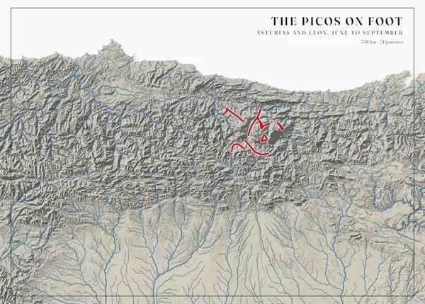 Landscape poster of the Cantabrian Mountains on a white background, the drainage network drawn in bold steel blue over soft grey relief — rivers running north to the sea and south onto the plain — with crimson walking routes in the Picos de Europa at the centre. The title reads The Picos on foot.